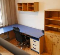 Heimbüro mit blauem Schreibtisch und Holzmöbeln in einer 3-Zimmer-Wohnung.