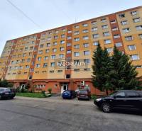 Wohnhaus in Prievidza mit Parkplätzen und Grünflächen, geeignet für eine 3-Zimmer-Wohnung.