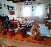 Gemütliches Zimmer in einer Hütte mit Tisch, Bett und dekorativen Gegenständen.