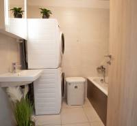 Badezimmer in einer 3-Zimmer-Wohnung mit Waschmaschine, Trockner und Badewanne.