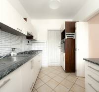 Küche einer 3-Zimmer-Wohnung mit gefliester Wand, Doppelspüle und eingebautem Ofen.