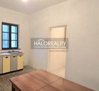 Küche in einem Einfamilienhaus mit Schrank, Tisch, Tür und Fenster.