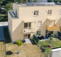 Gelbes Wohnhaus in der Železničná-Straße in Bratislava-Vrakuňa mit Garten und Parkplätzen.