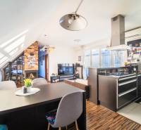 Küche mit Fernseher, Kamin und Holzboden in einer 2-Zimmer-Wohnung.