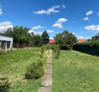 Grundstück für Wohnzwecke in der Nezvalova-Straße in Bratislava - Podunajské Biskupice, umgeben von Grünflächen.