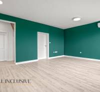 Ein Zimmer mit Holzboden, grünen Wänden und Klimaanlage, 2-Zimmer-Wohnung.