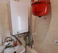 Gasheizung mit Waschbecken in Geschäftsräumen, Fliesenboden, Wände mit Fliesen verkleidet.