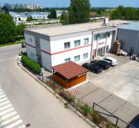 Geschäftsräume in der Strojárenská-Straße in Trnava, mit Parkplatz und umliegender Bebauung.