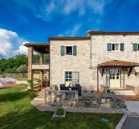 Steinvilla in Bale mit Pool und Terrasse, umgeben von Grün.