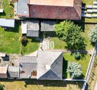Ein Einfamilienhaus in Ondrejovce mit Anbauten, Garten und angrenzender Straße.
