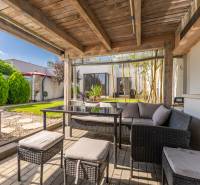 Die Terrasse des Einfamilienhauses in der Jazdecká-Straße in Trnava mit Rattanmöbeln und einem versteckten Pool.