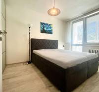 Schlafzimmer mit Doppelbett, Bild und Stehlampe in einer 3-Zimmer-Wohnung.