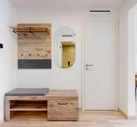 Eingangsbereich, Boden mit Holzdekor, Bank, Spiegel, Garderobe. 2-Zimmer-Wohnung.