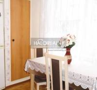 Esszimmer in einer 3-Zimmer-Wohnung mit Holzboden und hellen Vorhängen.