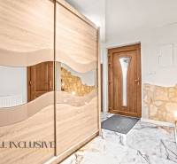 Eingangsbereich in einem Einfamilienhaus mit einem Schiebeschrank und Türen in Holzoptik.