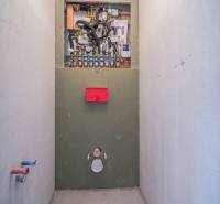 Installation von sanitären Anlagen in einer Zweizimmerwohnung mit Holzbodenoptik.