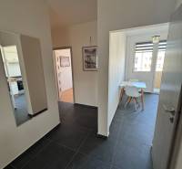 Flur mit dunklen Fliesen und Esszimmer in einer 3-Zimmer-Wohnung.