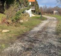 Freizeitgrundstücke Horné Jabloňovce in Jabloňovce mit einem Gehweg neben einem kleinen Haus und Bäumen.