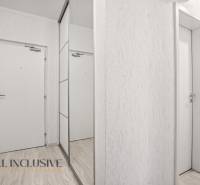 Weiße Innentüren und ein Spiegelschrank in einer 3-Zimmer-Wohnung mit einem Boden in Holzoptik.