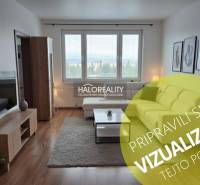 Wohnzimmer in einer 3-Zimmer-Wohnung mit Holzboden und großen Fenstern.