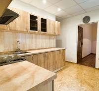 Küche in einer 3-Zimmer-Wohnung mit Küchenzeile und Boden in Holzoptik.