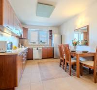 Küche in einer 2-Zimmer-Wohnung mit Holzdekor und Esstisch.