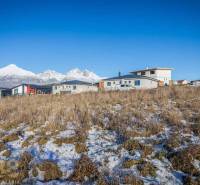 Grundstücke zum Wohnen in Mlynica mit Panoramablick und modernen Gebäuden im Hintergrund.