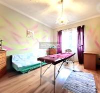 Ein Zimmer im Einfamilienhaus mit einem Massagetisch und einem Boden in Holzoptik.