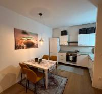 Küche und Esszimmer in einer Zweizimmerwohnung mit Holzboden.