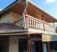 Eine Hütte in Byšta mit einer Terrasse und einer Holzbalkondekoration.