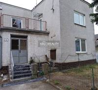 Ein Einfamilienhaus in Zemplín mit Treppe, Balkon und einem dünnen Zaun.