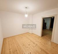 Ein leerer Raum in einem Einfamilienhaus mit Holzboden und einfacher Beleuchtung.