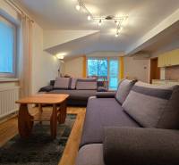 Helles Wohnzimmer im Ferienapartment mit bequemen Sofas und Holzbodenoptik.