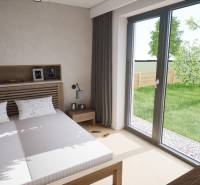 Schlafzimmer im Einfamilienhaus mit Ehebett, großem Fenster und Blick in den Garten.