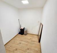 Ein kleiner Raum in einer Einzimmerwohnung mit einem Boden in Holzoptik.