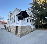 Das Gebäude in der Vajanského-Straße in Prešov mit einem eleganten Steinsockel und einer weißen Fassade.