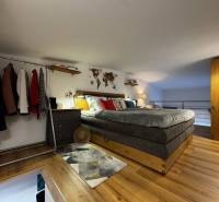 Schlafzimmer mit Bett, Kleiderschrank und Boden mit Holzdekor, Einrichtung aus Lagern und Hallen.