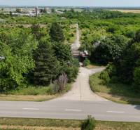 Ein von Grün umsäumter Weg bietet einen Blick auf Gewerbegrundstücke in Ivanka pri Nitre.