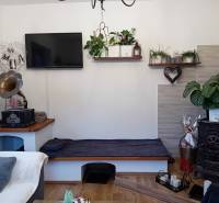 Innenraum eines Einfamilienhauses mit Kamin, Plattenspieler und Dekorationen auf einem Boden mit Holzdekor.