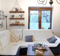 Wohnzimmer in einem Einfamilienhaus mit Sofa, Fotogalerie, Regalen und Dekorationen.