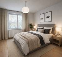 Ein Schlafzimmer in einer 3-Zimmer-Wohnung mit einem Doppelbett und einem Boden in Holzoptik.