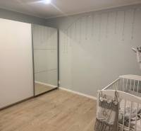 Kinderzimmer in einer 3-Zimmer-Wohnung mit Holzboden, Kinderbett und Kleiderschrank.