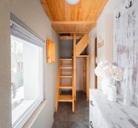 Das Innere der Hütte mit einer Holztreppe und einem Fenster mit Blick nach draußen.