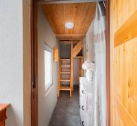 Ein heller Flur in einer Hütte mit Holztreppe und dekorativen Elementen.