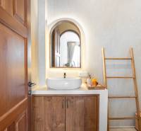 Badezimmer in der Villa mit Spiegel, Waschbecken und Leiter als Dekoration.