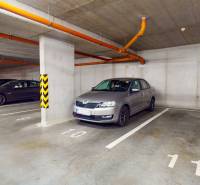 Unterirdischer Parkplatz in Zuzany Chalupovej, Bratislava - Petržalka, mit mehreren geparkten Autos.