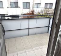 Der Balkon einer Einzimmerwohnung in Bratislava - Janíkov dvor mit Blick auf die benachbarten Gebäude.