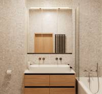 Badezimmer in einer 4-Zimmer-Wohnung mit einem Schrank in Holzoptik und einer Badewanne.