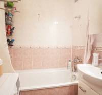 Badezimmer mit Badewanne, Waschbecken und Stauraum in einer 3-Zimmer-Wohnung.