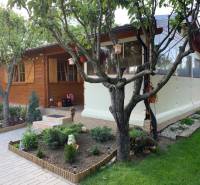 Ein hölzernes Gartenhaus umgeben von Grün in den Gärten von Dolné Krškany in Nitra.